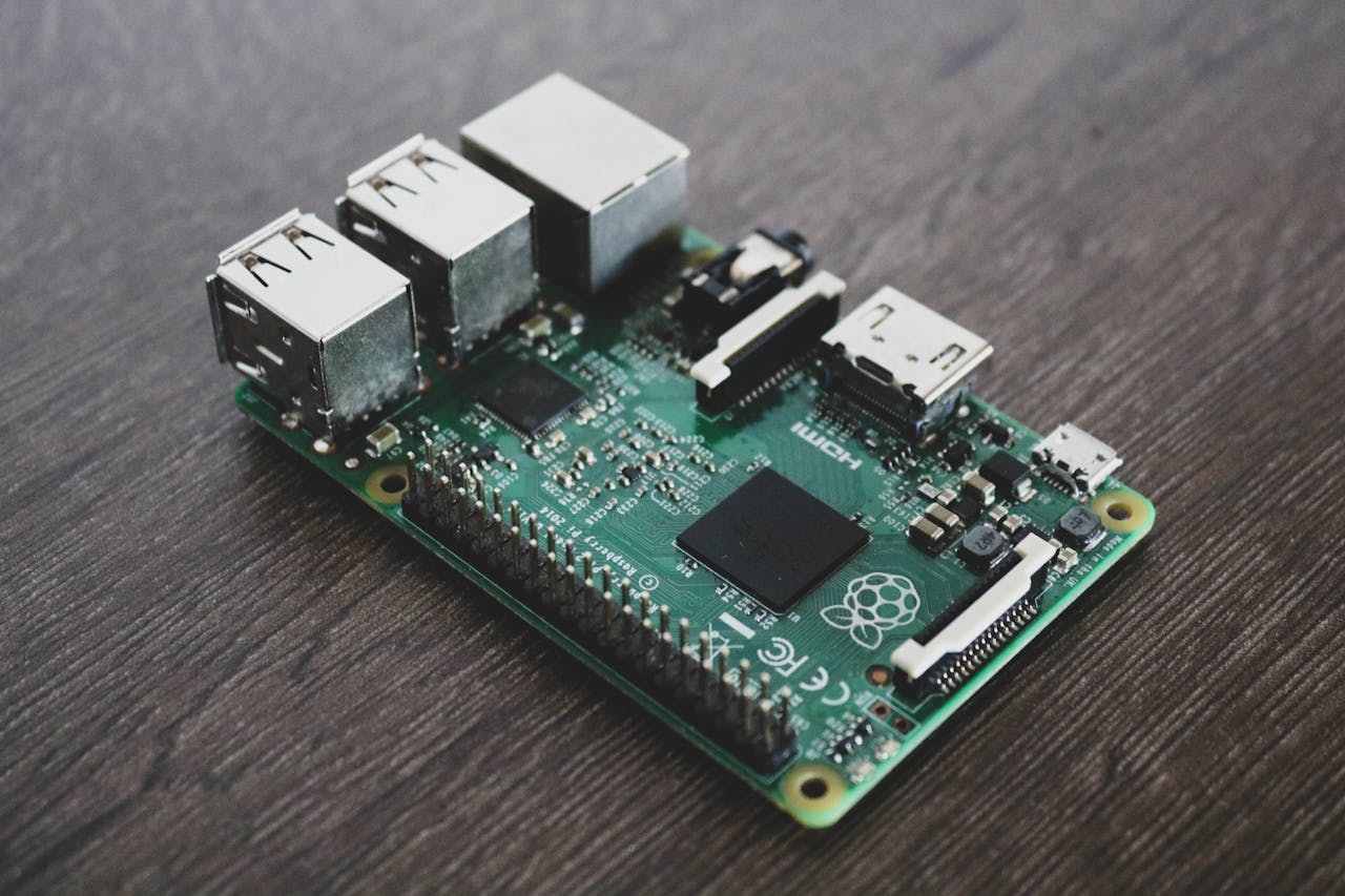 who-we-are Detailed view of a Raspberry Pi circuit board with microchips and components.